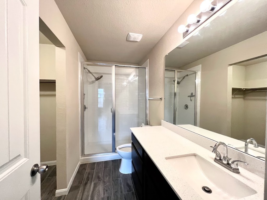 3208 Tilmon Ln. Austin, TX 78725 - Photo 11 of 21 a bathroom with a sink a shower and a mirror