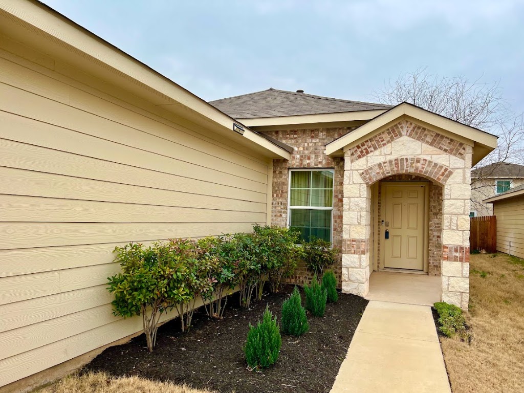 3208 Tilmon Ln. Austin, TX 78725 - Photo 2 of 21 a front view of a house with a garden