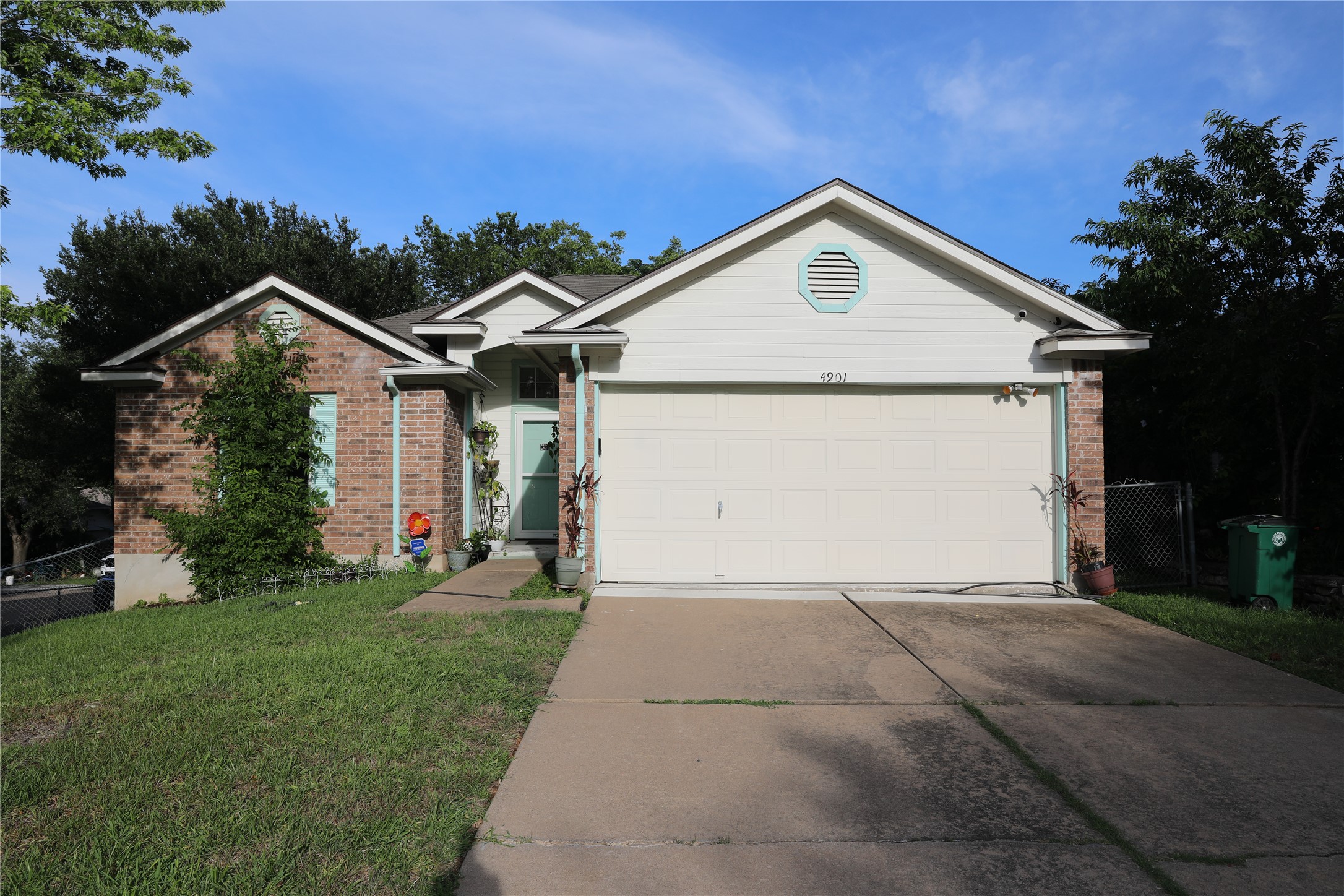 4901 Birch Creek Road Austin, TX 78744 - Photo 3 of 11 A classic brick and siding home features a welcoming front entry and convenient garage.