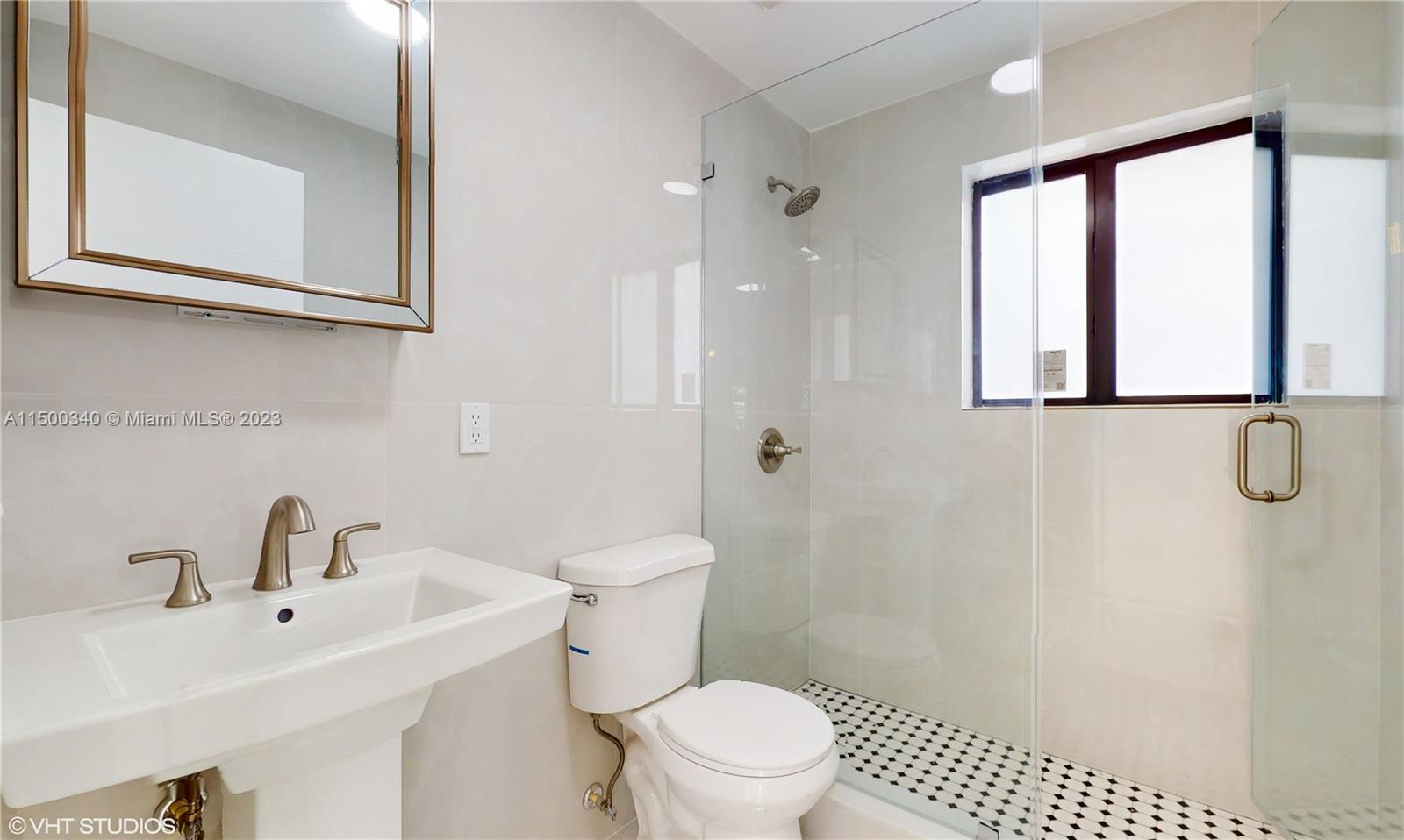 325 Southwest 30th Road, Unit L Miami, FL 33129 - Photo 19 of 25 a bathroom with a sink a toilet and a shower