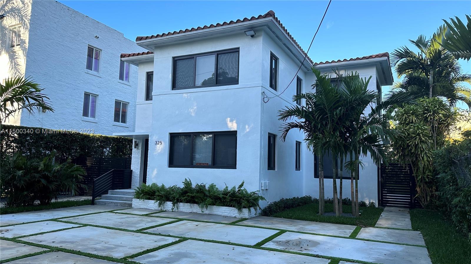 325 Southwest 30th Road, Unit L Miami, FL 33129 - Photo 2 of 25 a front view of a house with a garden