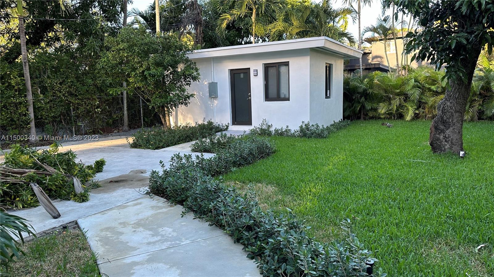 325 Southwest 30th Road, Unit L Miami, FL 33129 - Photo 22 of 25 a view of a house with backyard and garden