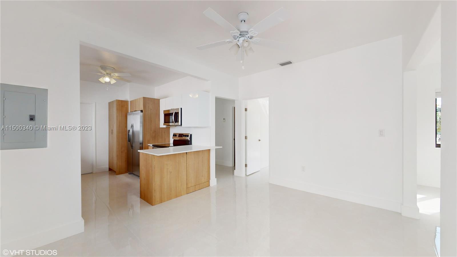 325 Southwest 30th Road, Unit L Miami, FL 33129 - Photo 10 of 25 a open kitchen with cabinets and stainless steel appliances