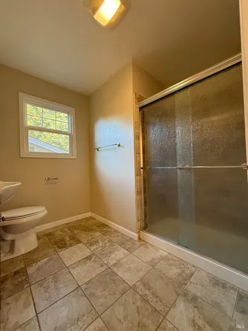 a bathroom with a shower and a toilet