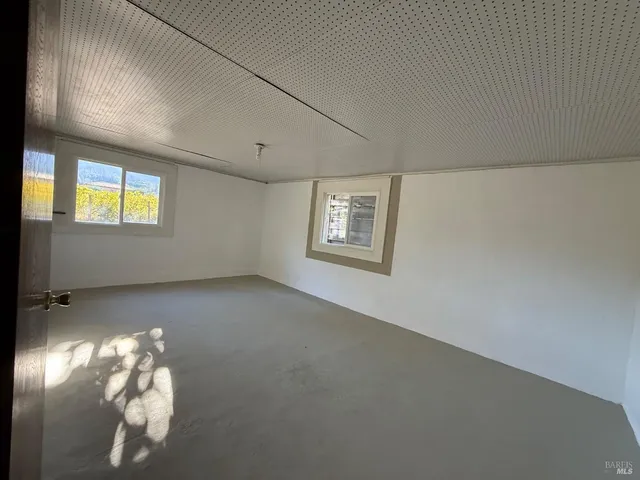 a view of empty room with windows