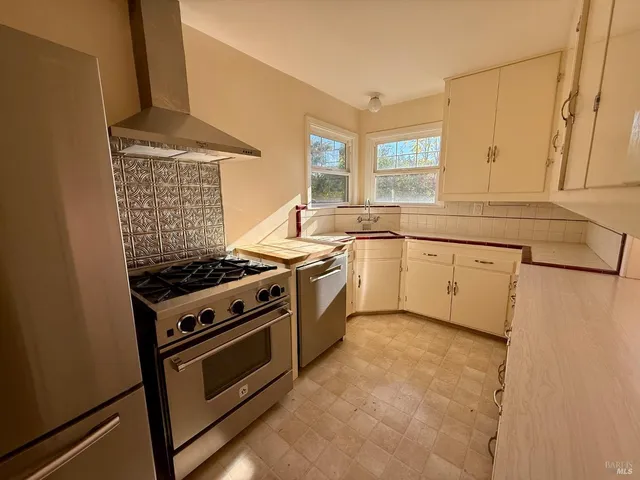 a kitchen with stainless steel appliances granite countertop a stove and a sink
