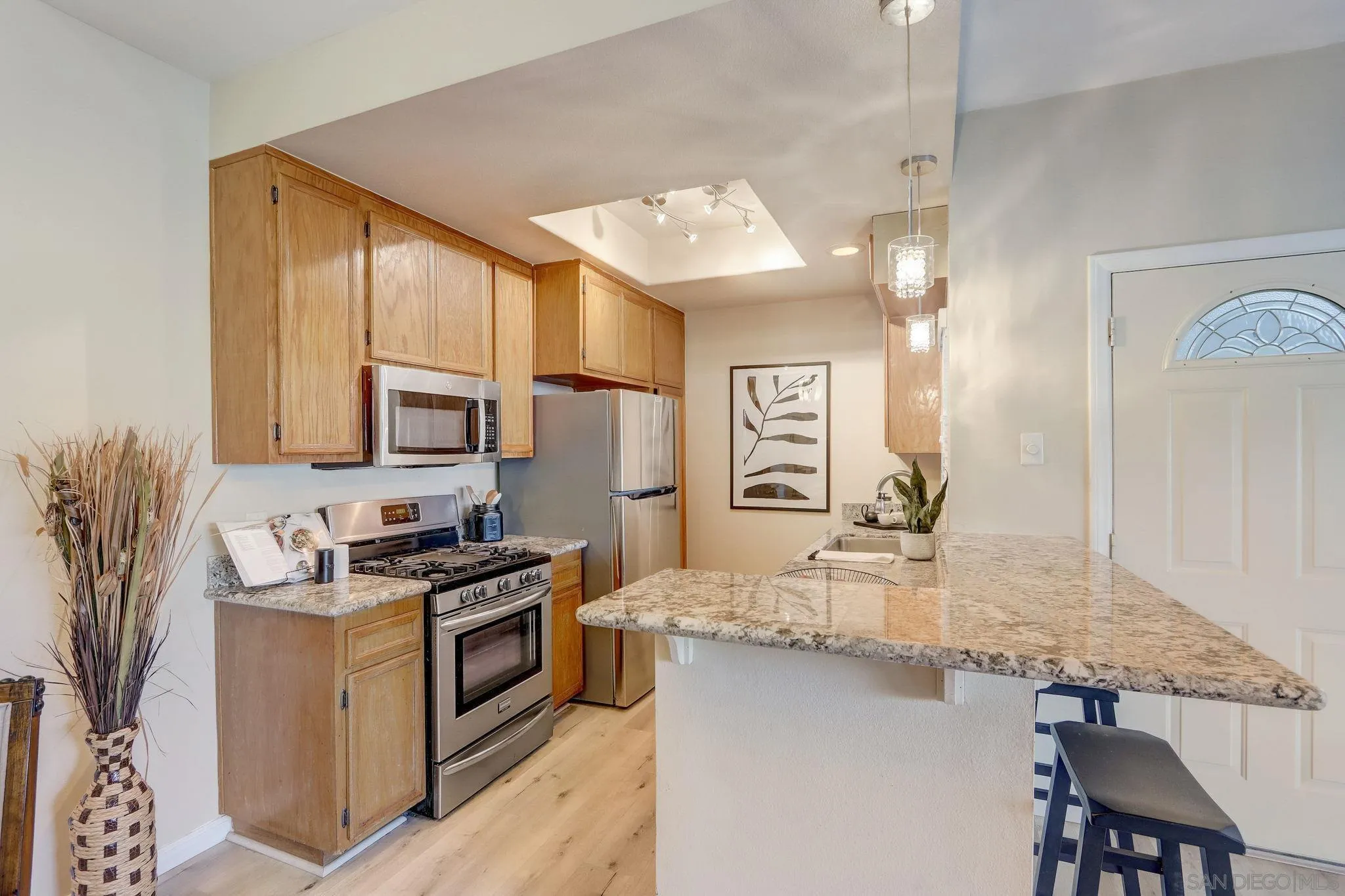 13832 Midland Road Poway, CA 92064 - Photo 11 of 36 a kitchen with granite countertop stainless steel appliances a sink stove and cabinets