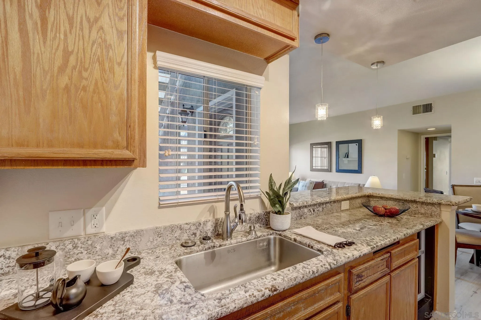 13832 Midland Road Poway, CA 92064 - Photo 15 of 36 a kitchen with granite countertop sink and natural light