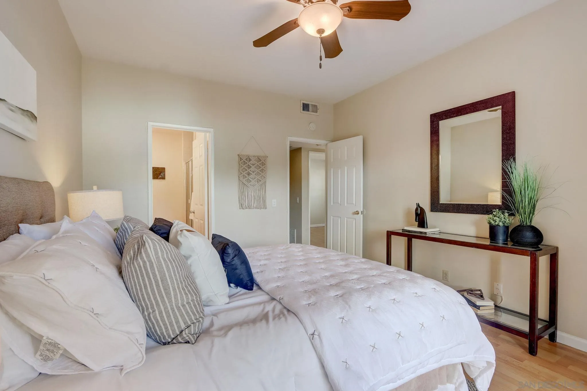 13832 Midland Road Poway, CA 92064 - Photo 18 of 36 a bedroom with a large bed and a chandelier