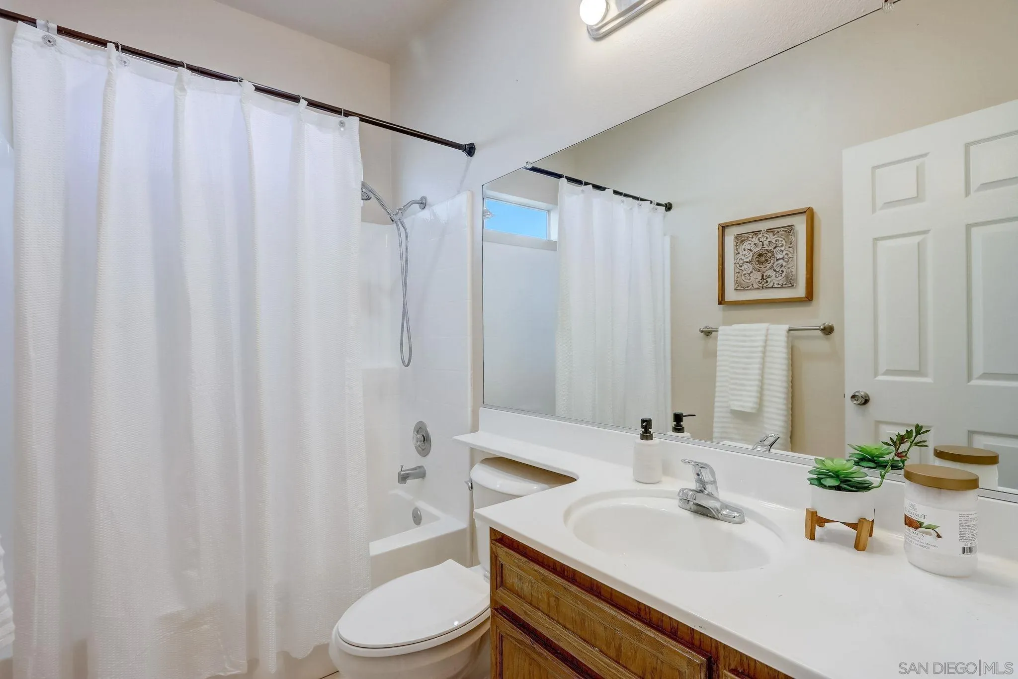 13832 Midland Road Poway, CA 92064 - Photo 25 of 36 a bathroom with a sink a toilet and shower curtain