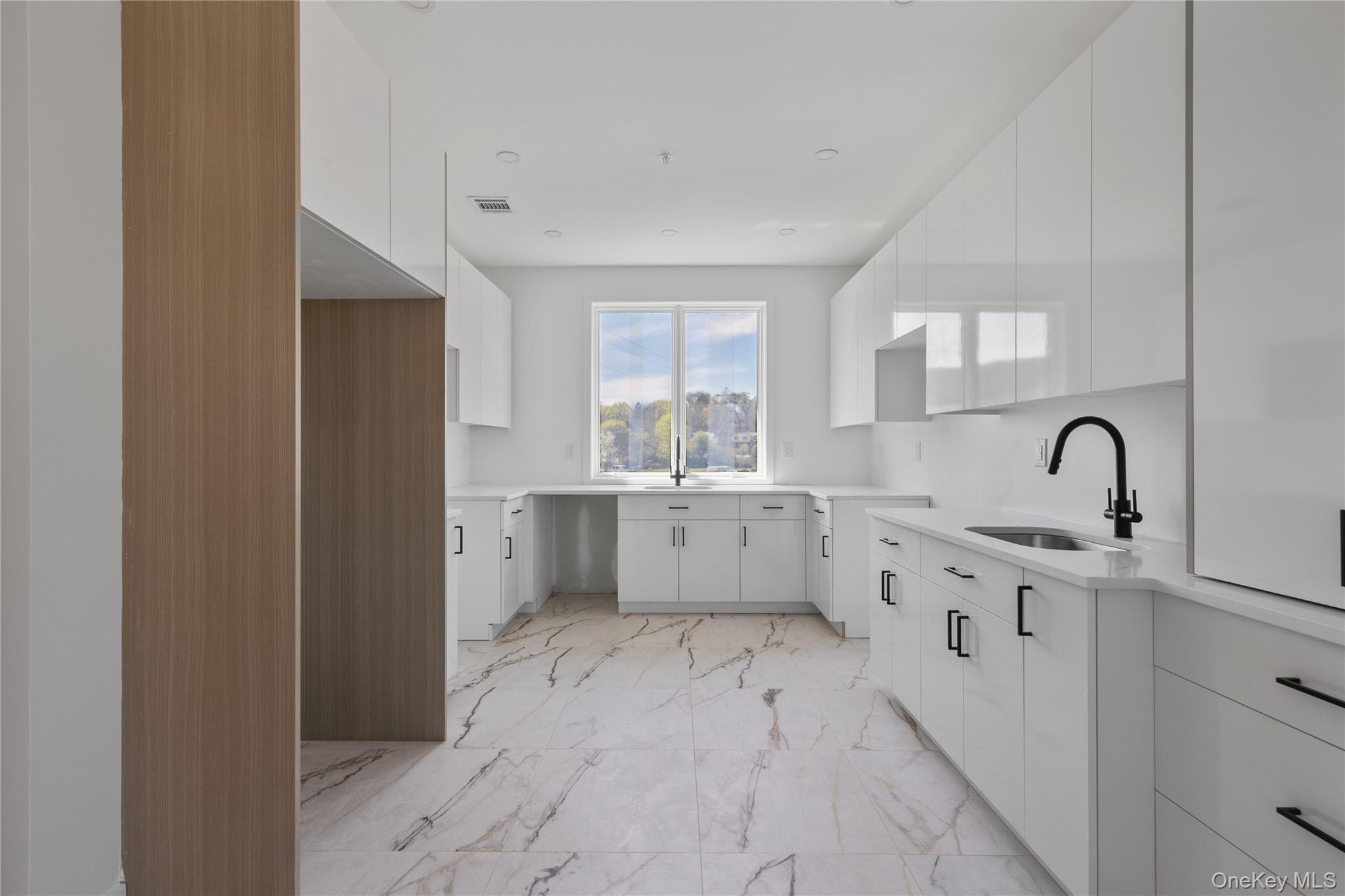 236 Old Nyack Turnpike, Unit 201 Spring Valley, NY 10977 - Photo 15 of 49 a large white kitchen with a sink a window and stainless steel appliances