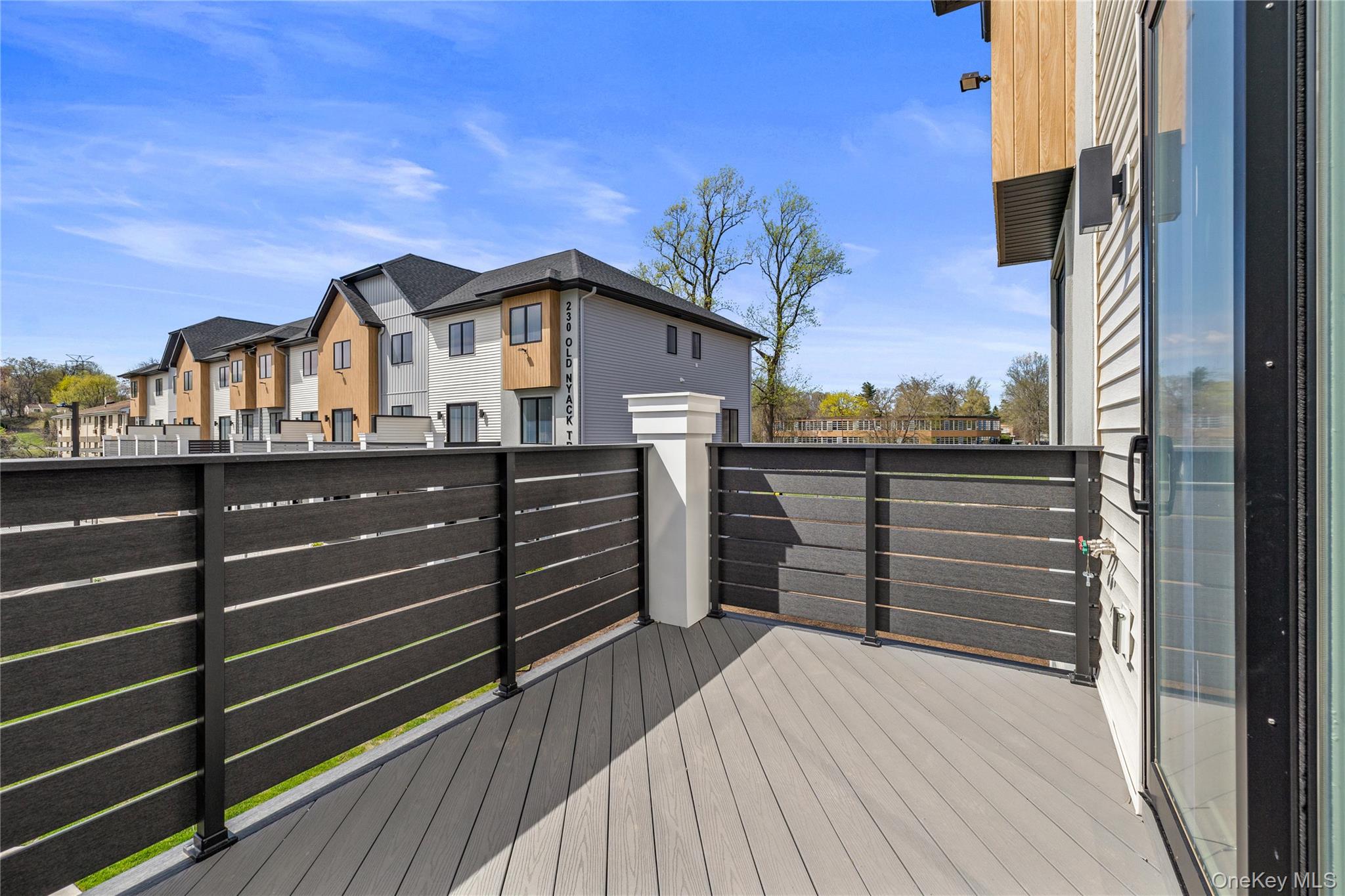 236 Old Nyack Turnpike, Unit 201 Spring Valley, NY 10977 - Photo 37 of 49 a view of a house with a balcony and wooden floor