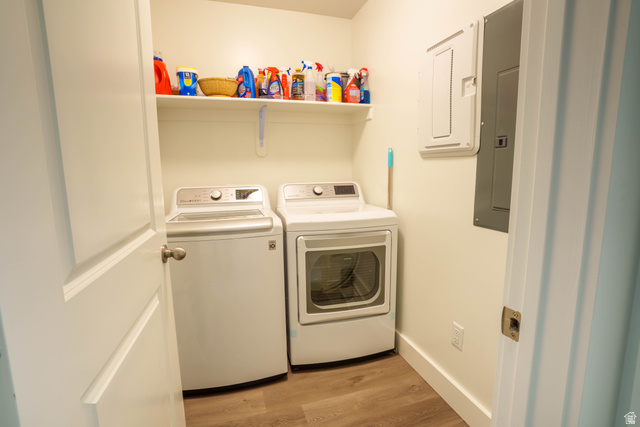 1486 West 2055th Street South Logan, UT 84339 - Photo 26 of 45 Dedicated laundry area featuring wood-finish flooring, a wall-mounted storage shelf, and crisp white trim