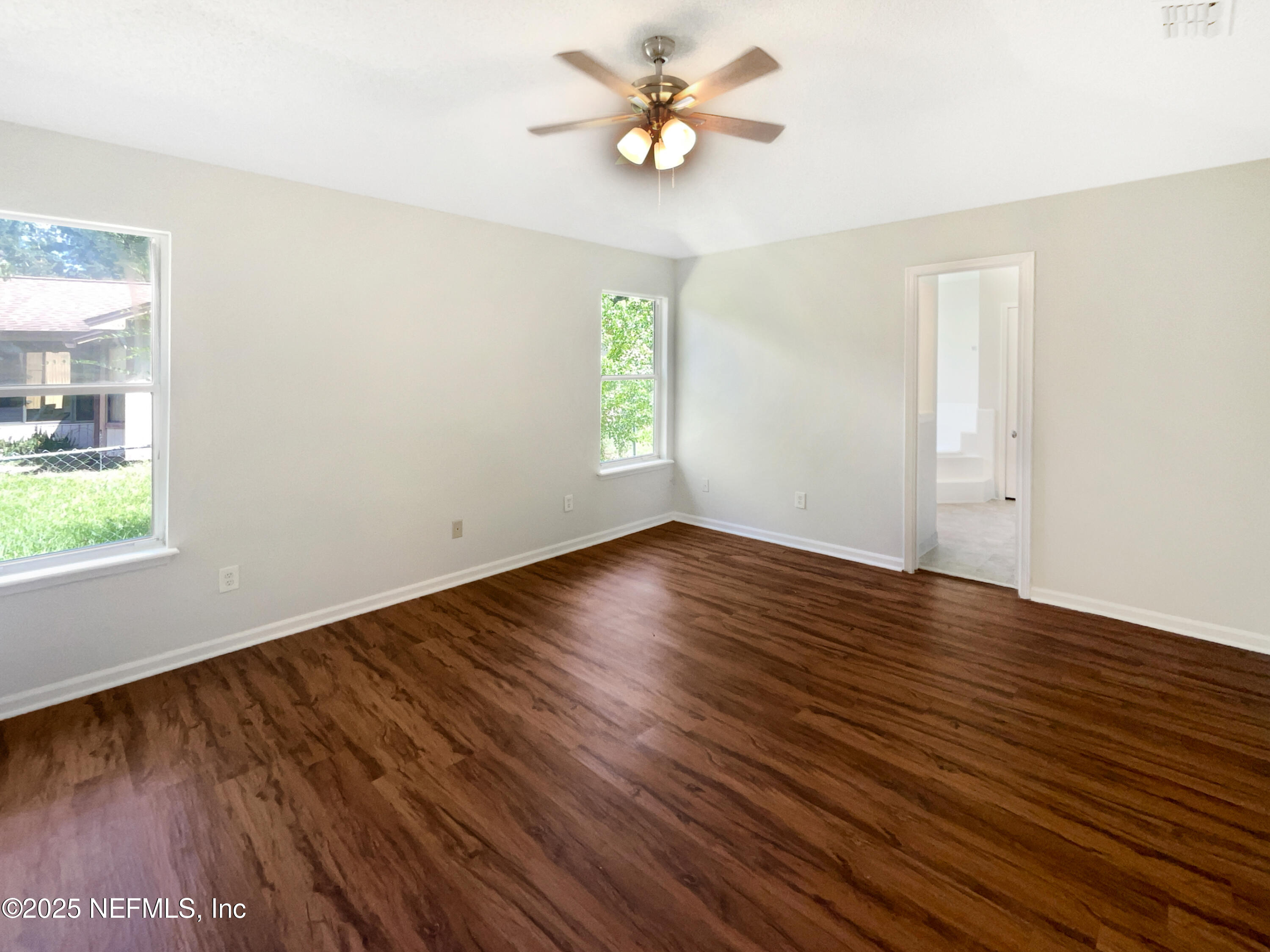 2058 Manucy Court Middleburg, FL 32068 - Photo 11 of 18 an empty room with wooden floor and windows