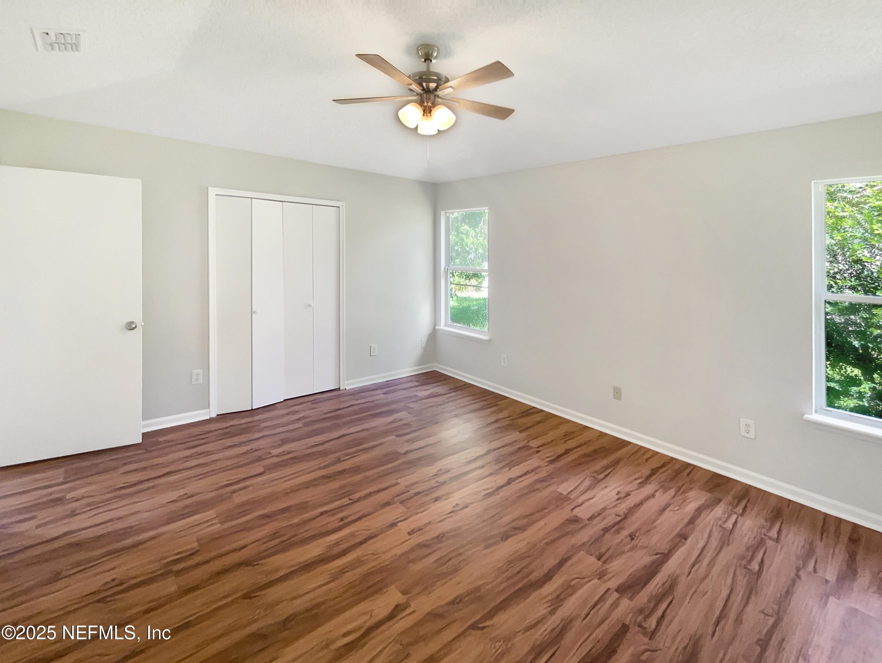 2058 Manucy Court Middleburg, FL 32068 - Photo 12 of 18 an empty room with wooden floor and windows