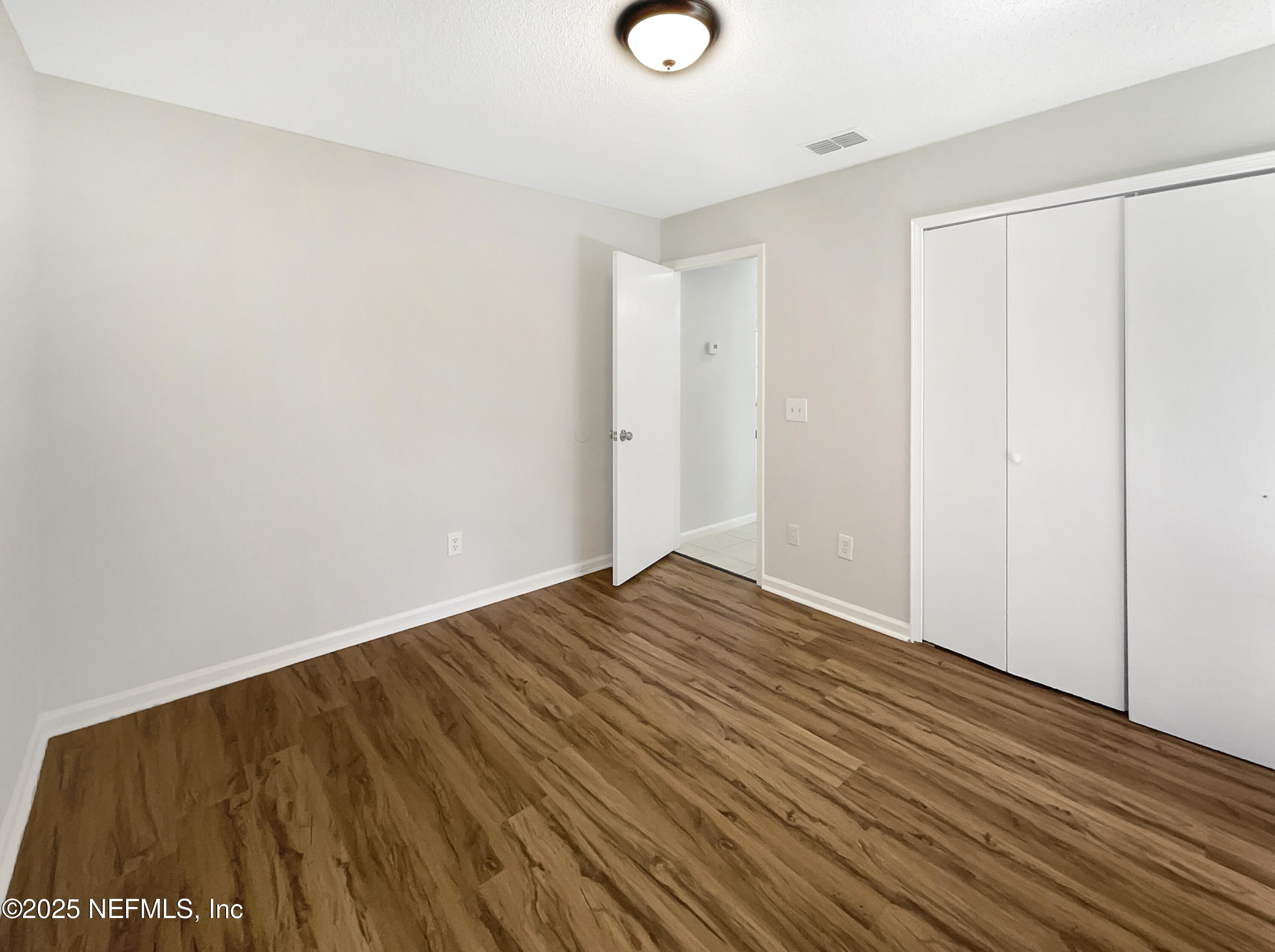 2058 Manucy Court Middleburg, FL 32068 - Photo 14 of 18 a view of an empty room with wooden floor