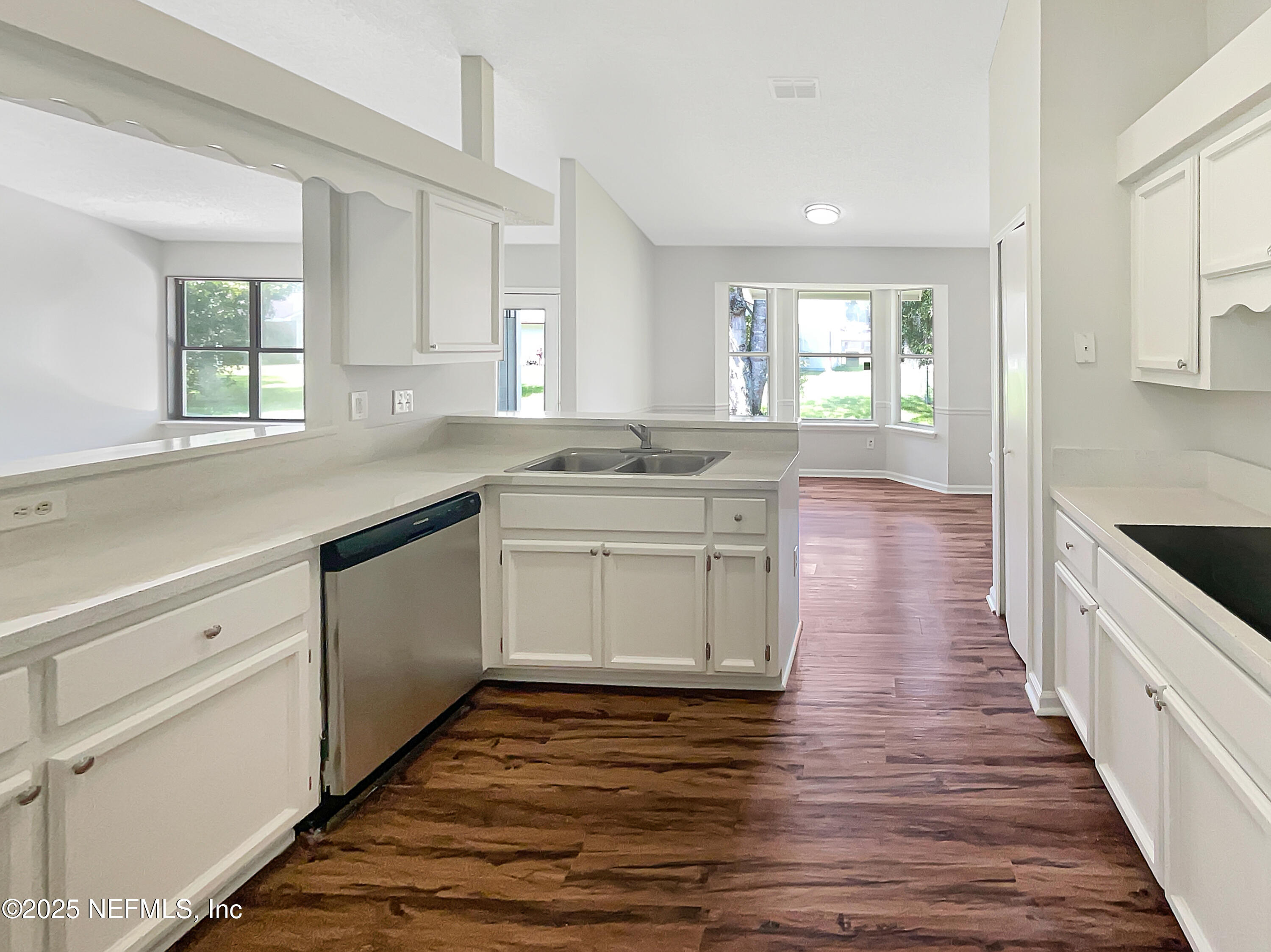 2058 Manucy Court Middleburg, FL 32068 - Photo 6 of 18 a kitchen with stainless steel appliances granite countertop a sink stove and cabinets