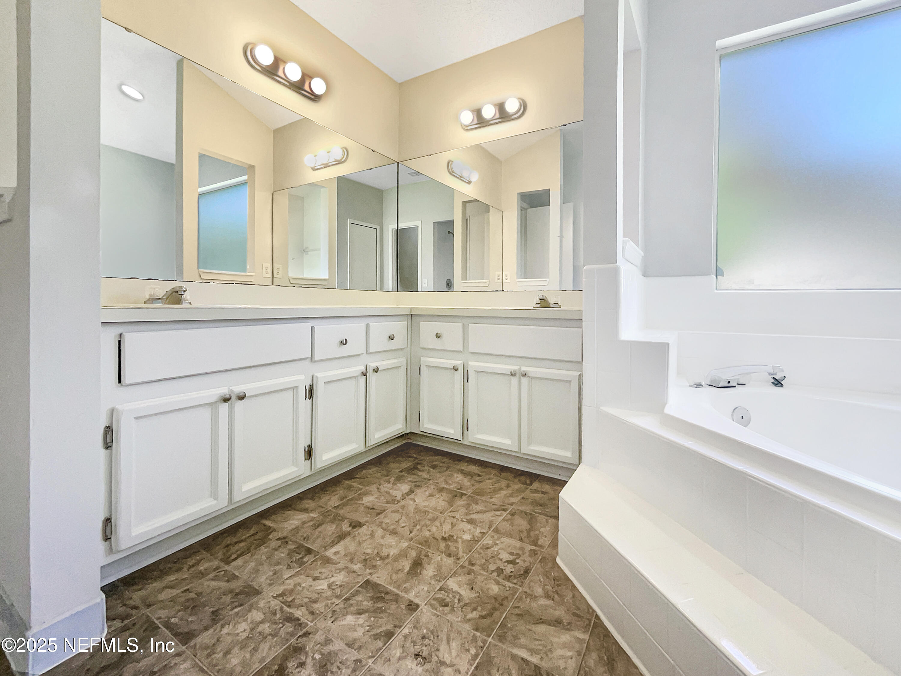 2058 Manucy Court Middleburg, FL 32068 - Photo 8 of 18 a spacious bathroom with a tub sink and mirror