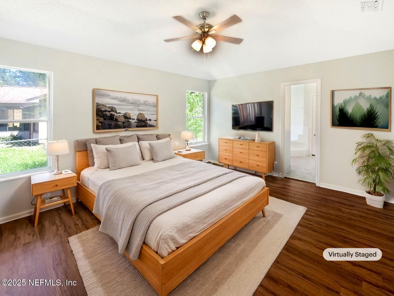 2058 Manucy Court Middleburg, FL 32068 - Photo 10 of 18 a bedroom with a bed a flat screen tv and a couch