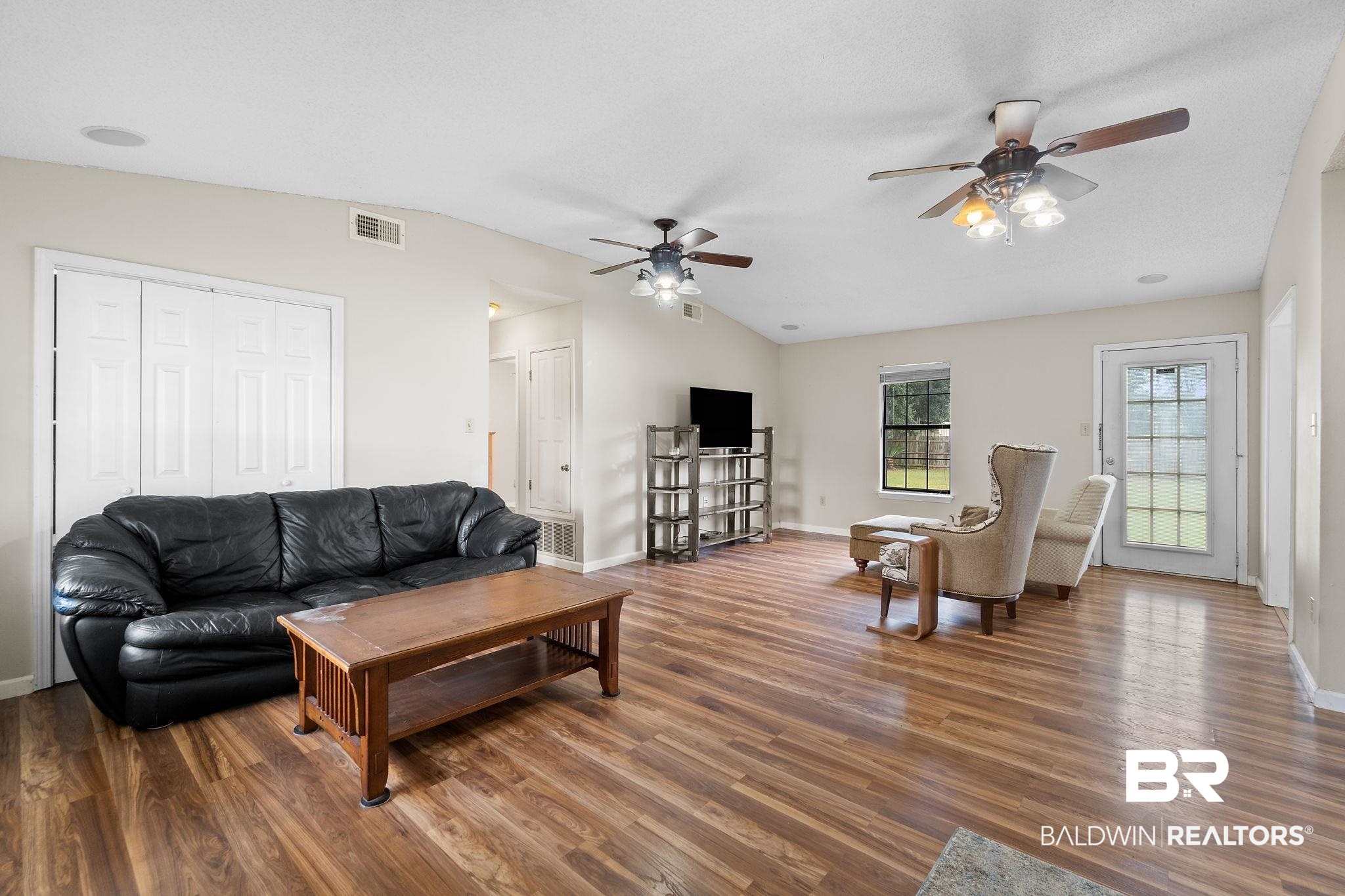 33135 Collier Road Lillian, AL 36549 - Photo 4 of 30 Living room featuring lofted ceiling, a ceiling fan, and wood finished floors