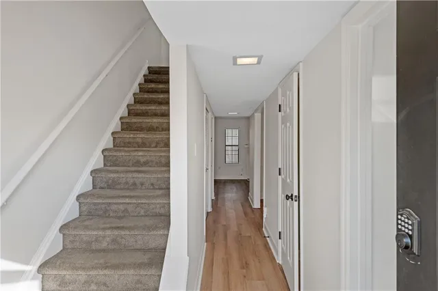 a view of a hallway with wooden floor and entryway
