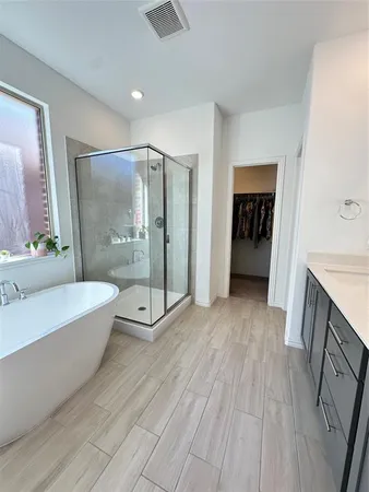 a bathroom with a bathtub and a sink