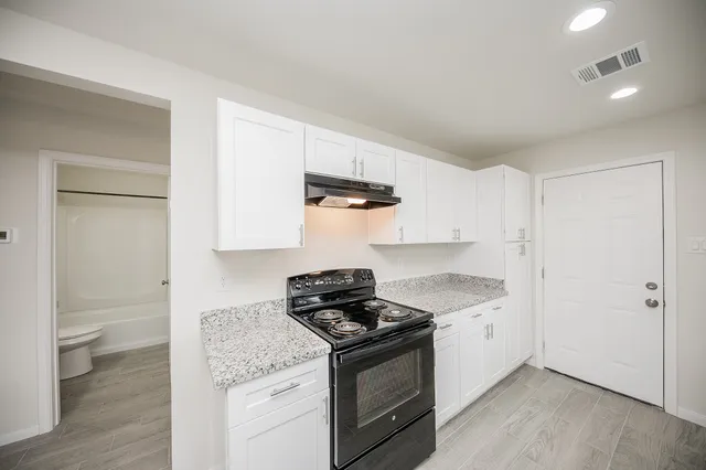 a kitchen with a stove and a refrigerator
