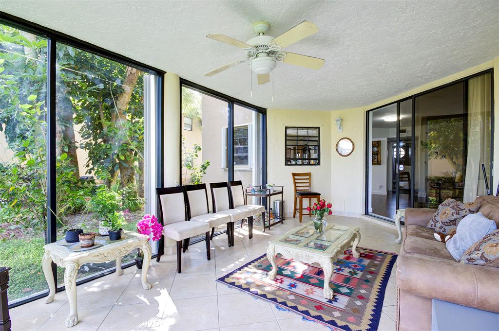 18258 Covina Way, Unit 102 Boca Raton, FL 33498 - Photo 11 of 26 a living room with furniture and a large window