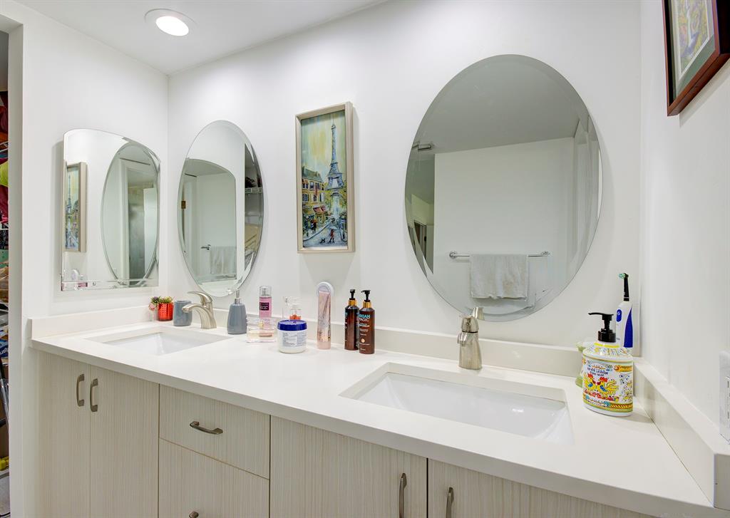 18258 Covina Way, Unit 102 Boca Raton, FL 33498 - Photo 14 of 26 a bathroom with double vanity sinks and a mirror