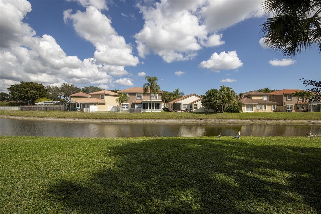 18258 Covina Way, Unit 102 Boca Raton, FL 33498 - Photo 17 of 26 a view of pool yard and outdoor seating