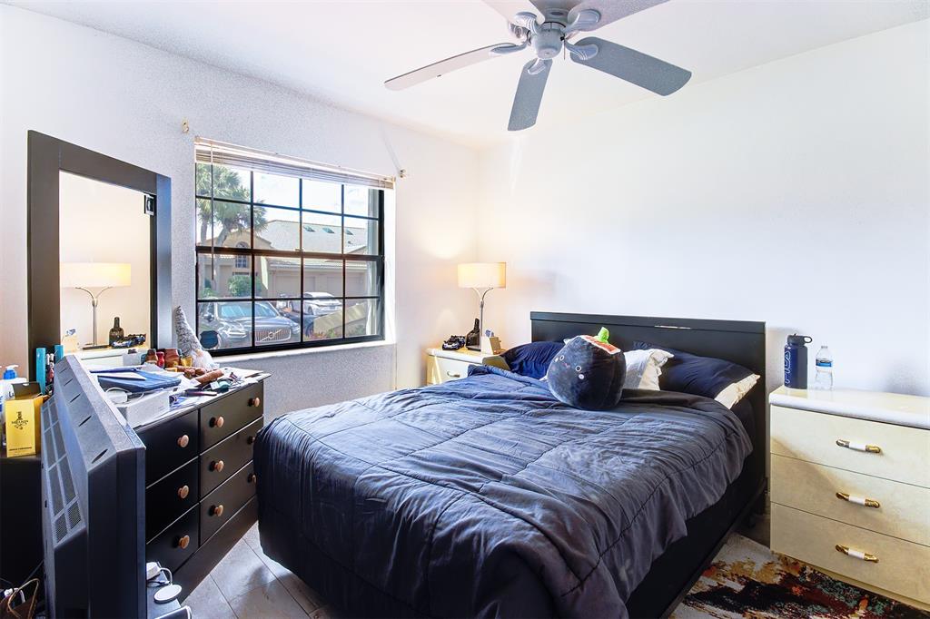 18258 Covina Way, Unit 102 Boca Raton, FL 33498 - Photo 18 of 26 a bedroom with a bed and a window