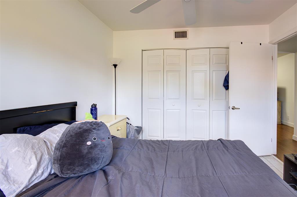 18258 Covina Way, Unit 102 Boca Raton, FL 33498 - Photo 19 of 26 a bed room with a bed and a flat tv screen