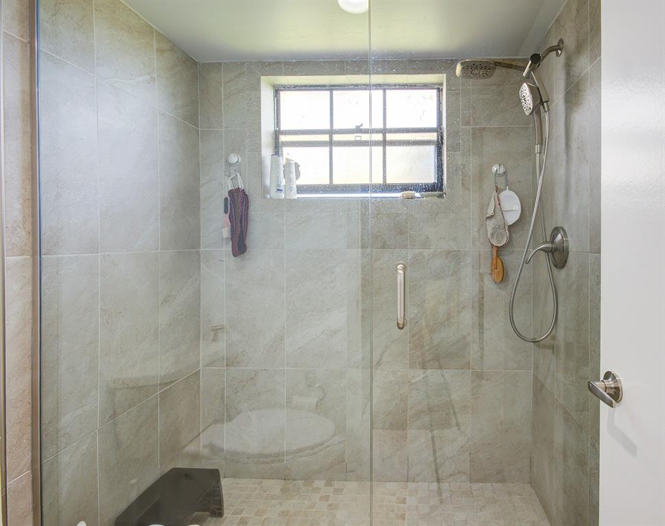 18258 Covina Way, Unit 102 Boca Raton, FL 33498 - Photo 20 of 26 a bathroom with a shower