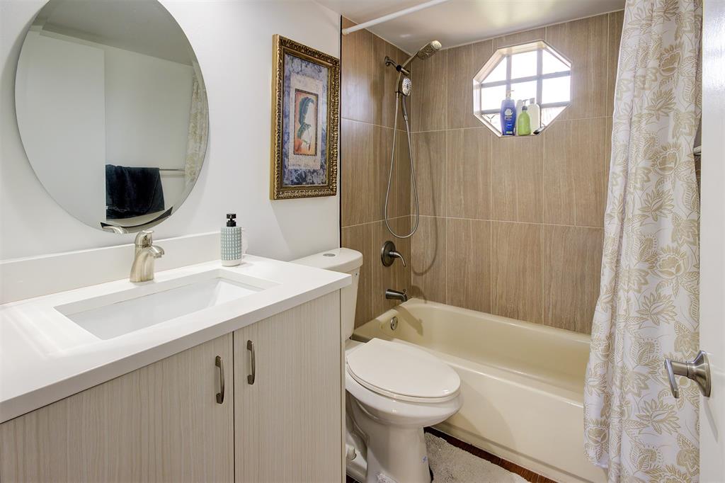 18258 Covina Way, Unit 102 Boca Raton, FL 33498 - Photo 21 of 26 a bathroom with a sink a toilet and shower