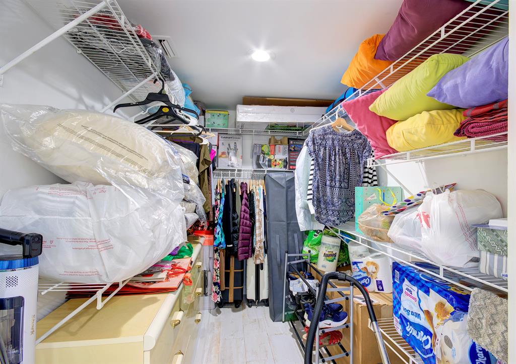 18258 Covina Way, Unit 102 Boca Raton, FL 33498 - Photo 22 of 26 a view of walk in closet with clothes and shoes