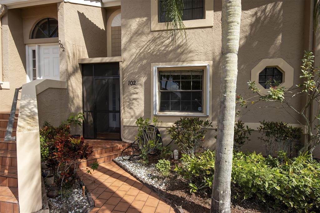 18258 Covina Way, Unit 102 Boca Raton, FL 33498 - Photo 23 of 26 a front view of a house with garden