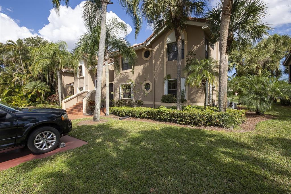 18258 Covina Way, Unit 102 Boca Raton, FL 33498 - Photo 24 of 26 a view of a house with a garden