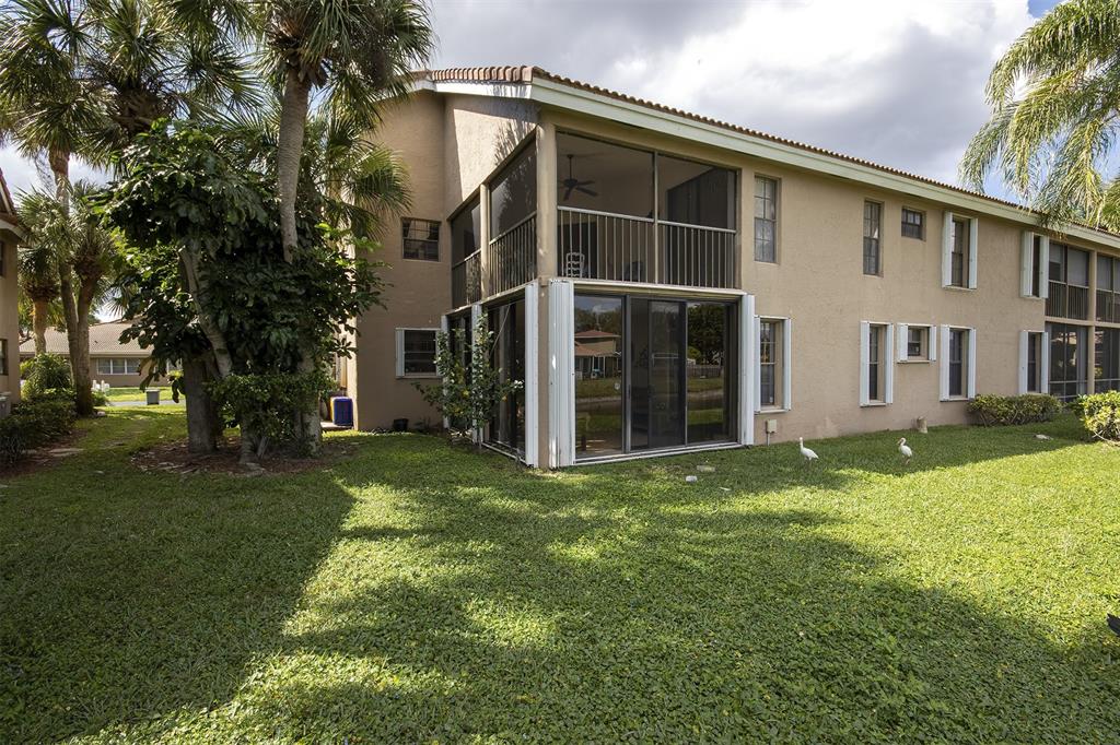 18258 Covina Way, Unit 102 Boca Raton, FL 33498 - Photo 25 of 26 a view of a house with a yard