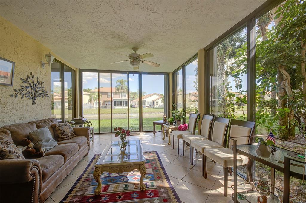 18258 Covina Way, Unit 102 Boca Raton, FL 33498 - Photo 10 of 26 a living room with furniture and a large window
