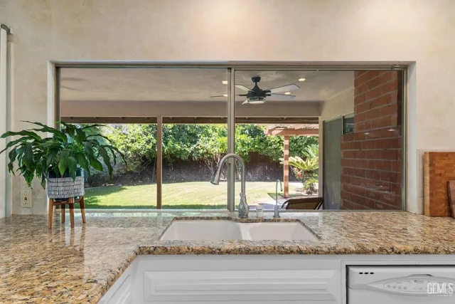 a bathroom with a sink a toilet and shower curtain
