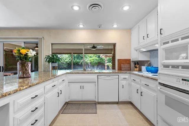 a living room with furniture large window and flat screen tv