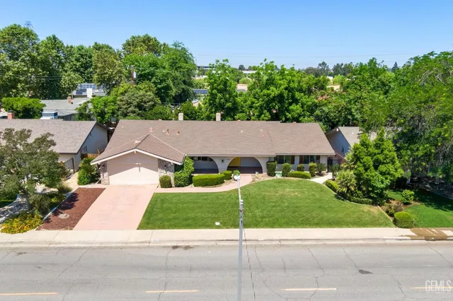 a house with green field in front of it