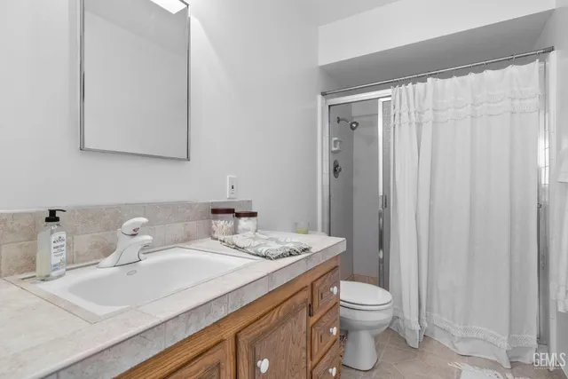 a bedroom with a bed and a mirror