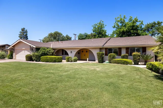 an aerial view of residential houses with outdoor space and ocean view