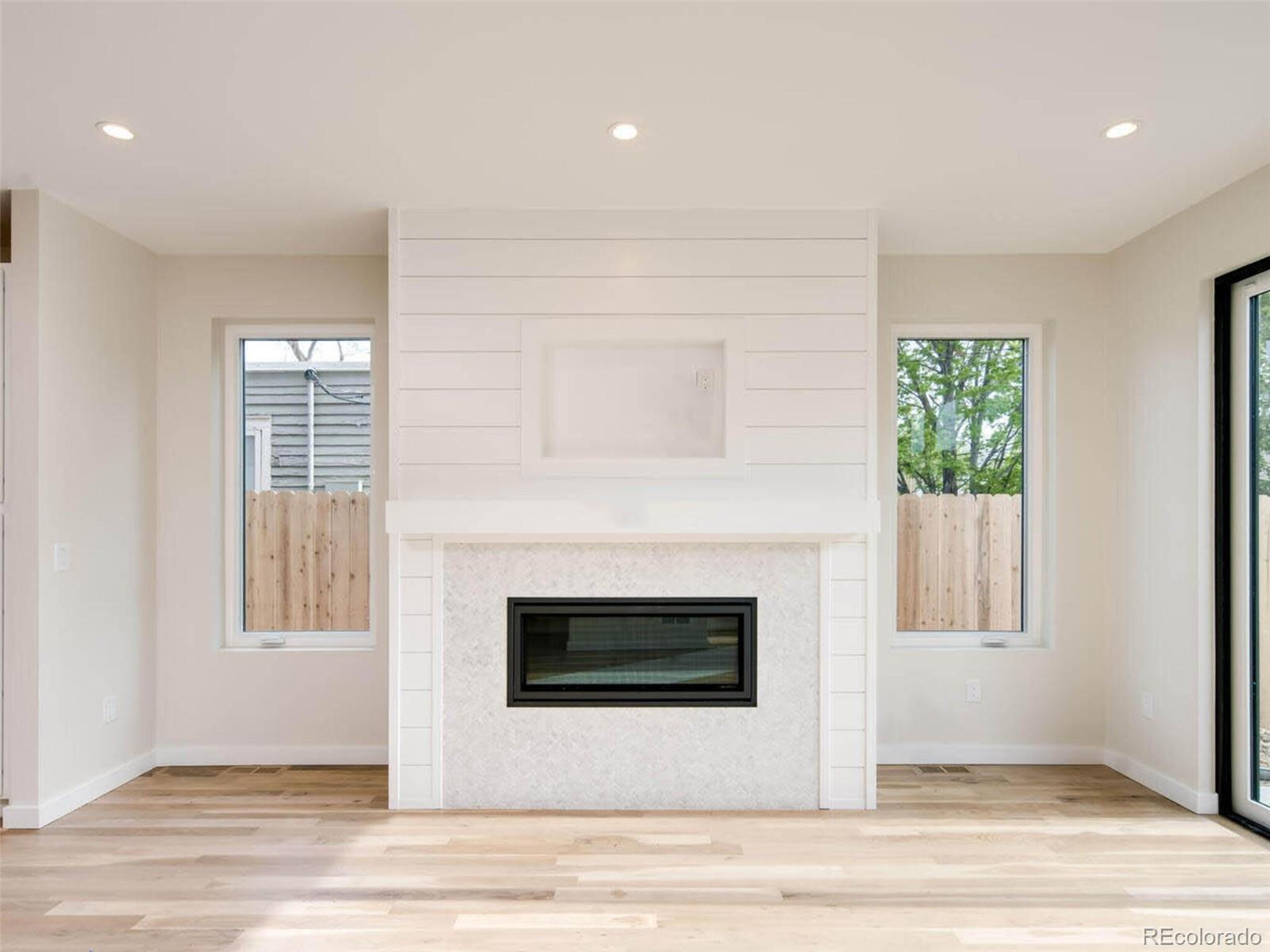2187 Julian Street Denver, CO 80211 - Photo 4 of 20 a view of a livingroom with a fireplace and wooden floor