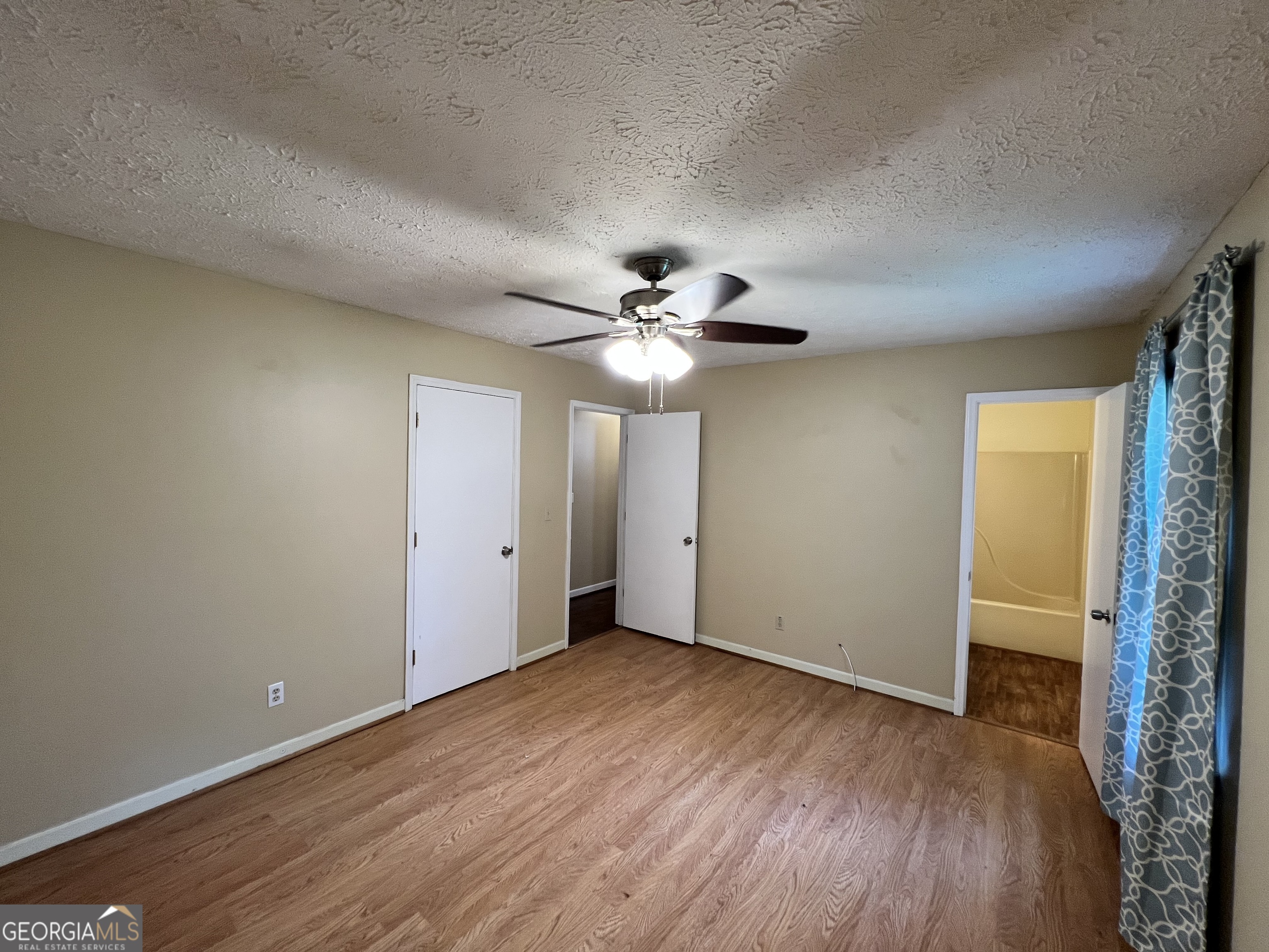 32 Ford Drive Southeast Rome, GA 30161 - Photo 16 of 49 an empty room with wooden floor fan and windows