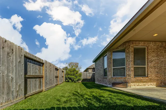 a view of house with backyard space and balcony