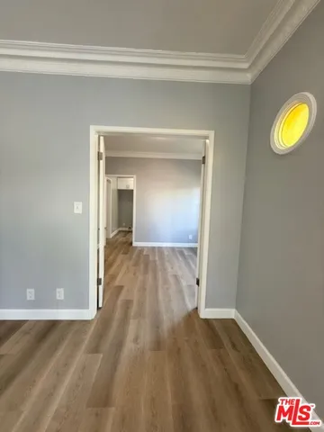 a view of hallway with wooden floor and livingroom