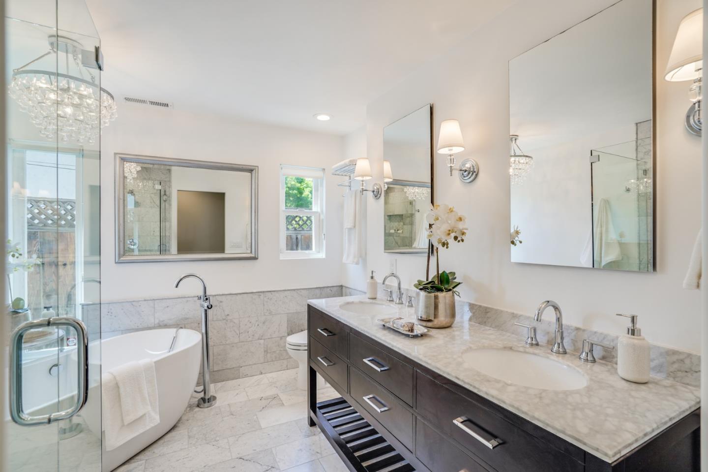 1564 Meadow Lane Mountain View, CA 94040 - Photo 18 of 36 a bathroom with double vanity sinks a large mirror and a bathtub