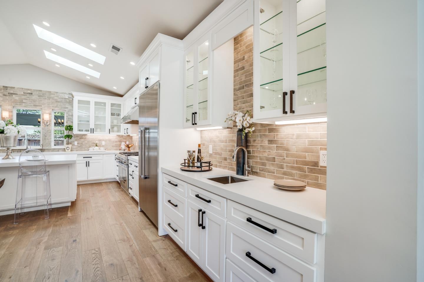 1564 Meadow Lane Mountain View, CA 94040 - Photo 6 of 36 a kitchen with stainless steel appliances kitchen island granite countertop a sink cabinets and wooden floor